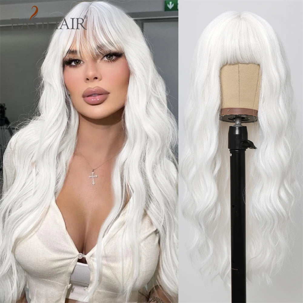 A close-up of a long white wavy wig with bangs displayed on a stand.