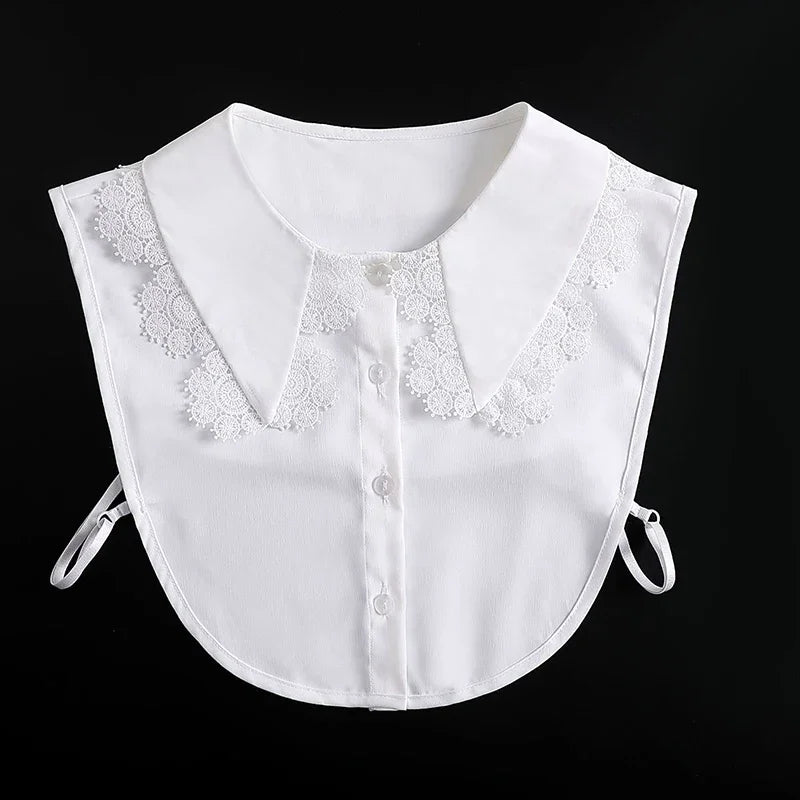 White blouse with a false collar featuring delicate lace trim on the neckline and adjustable straps.