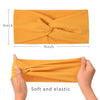A yellow fabric headband is shown folded and being worn by a hand, highlighting its soft and elastic texture.