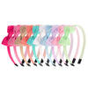 A collection of colorful grosgrain ribbon hair bows in various shades including pink, orange, blue, and green.