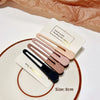 A set of five hand-made vintage frosted geometry hair clips in various neutral tones displayed on a white plate.