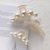 A set of simulated pearl hair claws, featuring round pearls attached to a flexible wire.