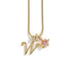 A gold-toned alphabet flower pendant necklace featuring a letter W and a pink gemstone.