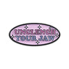 Purple enamel lapel pin with the text UNCLENCH YOUR JAW surrounded by stars