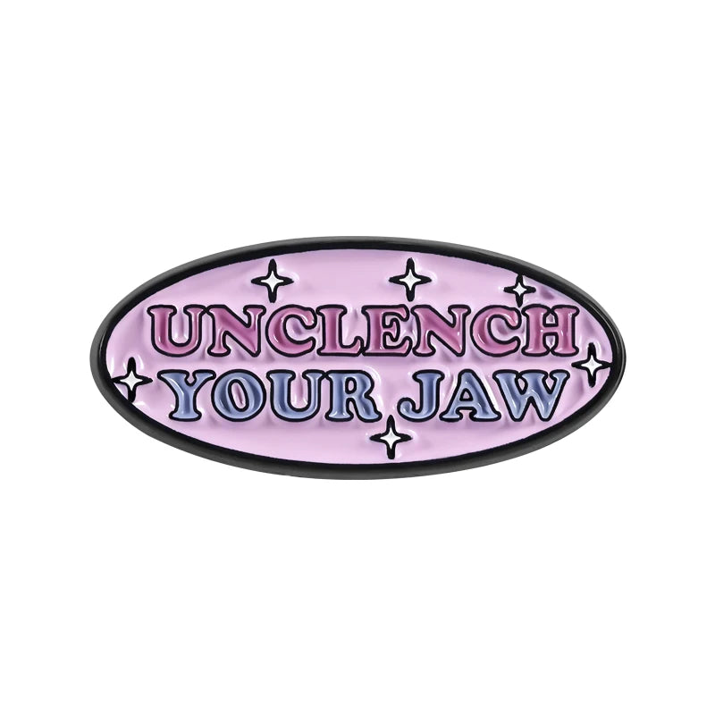 Purple enamel lapel pin with the text UNCLENCH YOUR JAW surrounded by stars