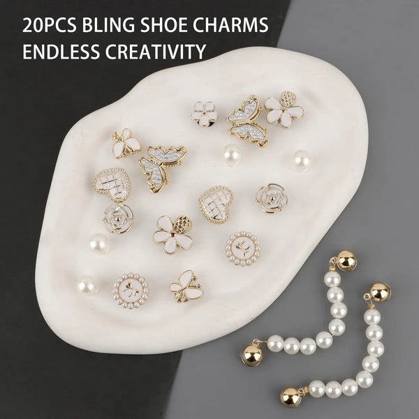 A collection of 20 pieces of sparkling rhinestone shoe charms and accessories displayed on a white oval surface.