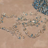 Silver stainless steel anklets featuring blue rhinestone pendants and chains.