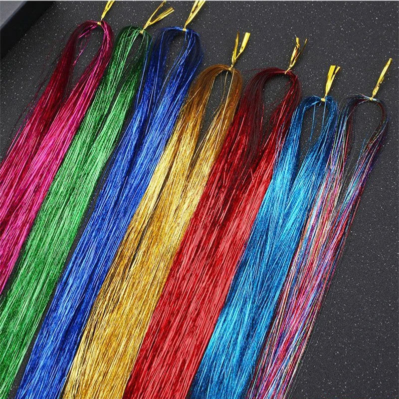 A collection of rainbow glitter hair extensions in various vibrant colors like pink, green, blue, and red.