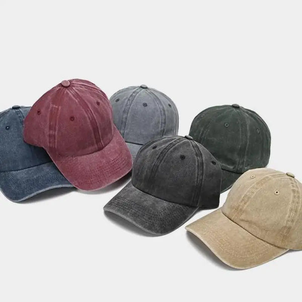 A collection of five snapback caps in various shades including maroon, gray, and olive green.