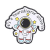 Enamel pin featuring a cartoon astronaut in space with stars and the text Its a neurodiverse universe