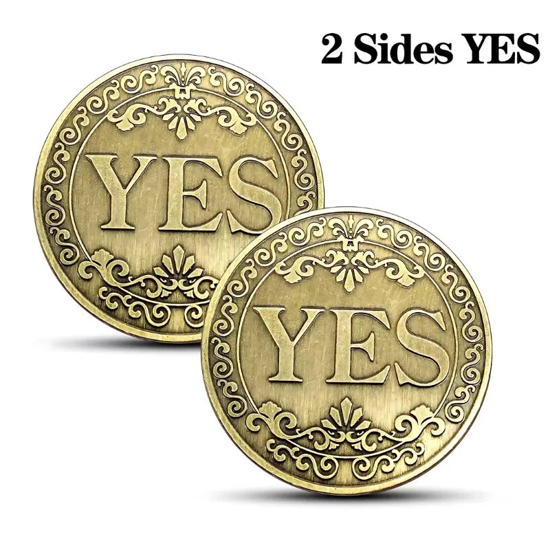 Two vintage antique bronze decision coins showing the word YES on both sides.