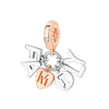 A delicate gold-toned family tree charm jewelry piece featuring initial letters and a heart.