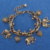 Vintage gold elephant charm bracelet featuring a chain and various animal motifs.