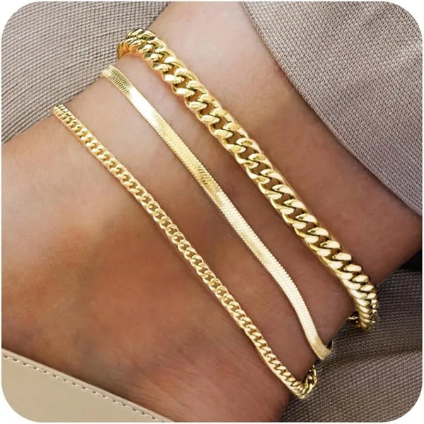 Three strands of 14K gold plated stainless steel anklets worn on a person's ankle.