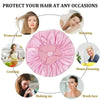 Pink satin hair rollers and styling tools used for protecting hair during various activities like sleeping, cooking, makeup, 