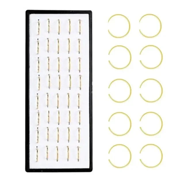 Stainless steel nose stud set for body piercing featuring multiple circular studs.