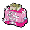 Pink enamel pin featuring a loaf of bread and cash wrapped in green money
