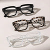 Three pairs of eyeglasses are displayed: black, leopard print, and clear plastic frames.