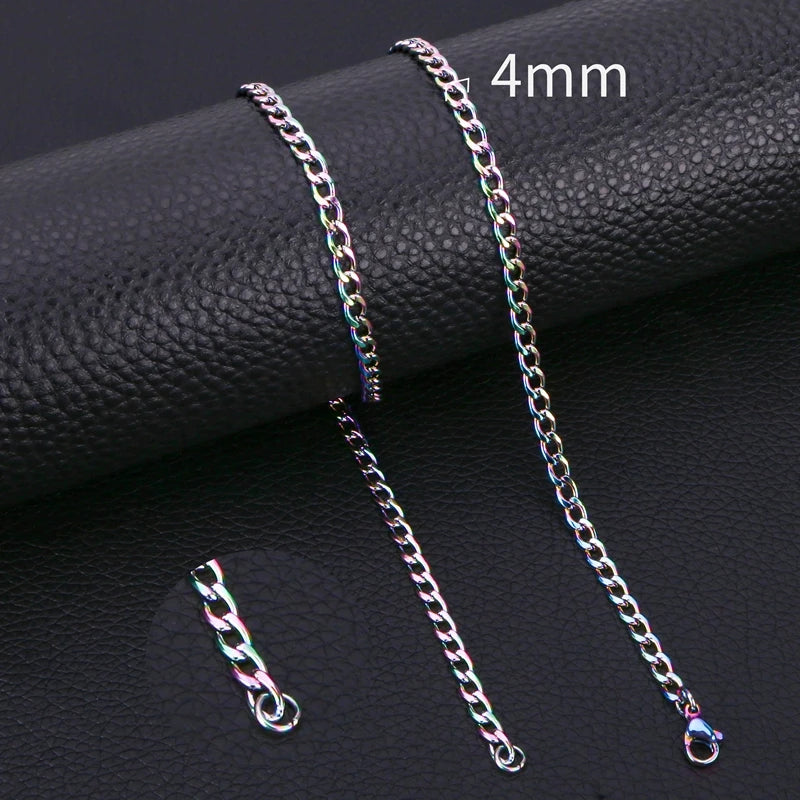 A close-up of a silver stainless steel Cuban link necklace displayed on a black surface.