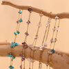 Multiple strands of gold-plated foot chains featuring crushed stone beads in shades of blue, purple, and pink.