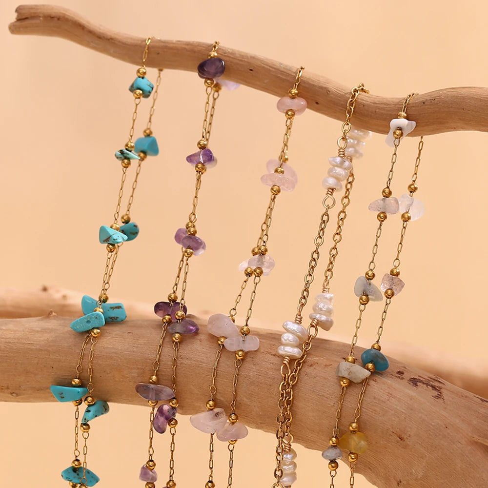 Multiple strands of gold-plated foot chains featuring crushed stone beads in shades of blue, purple, and pink.