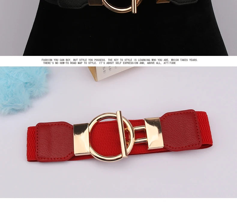 A red leather belt with a gold buckle is shown against a white background.