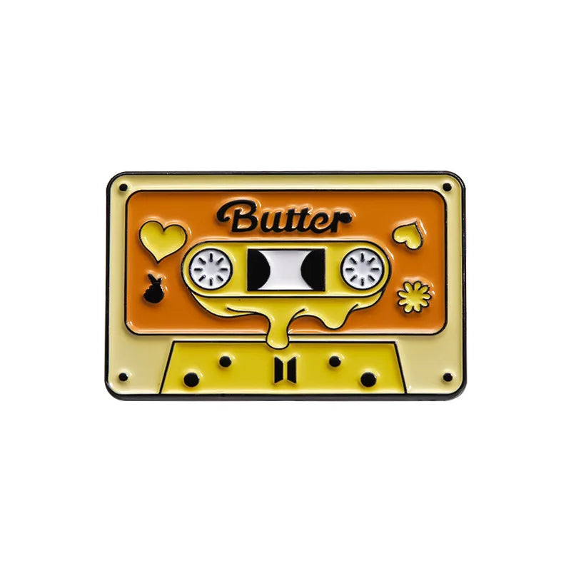 Retro fine line cassette enamel pin brooch featuring a yellow and orange design with a butter theme