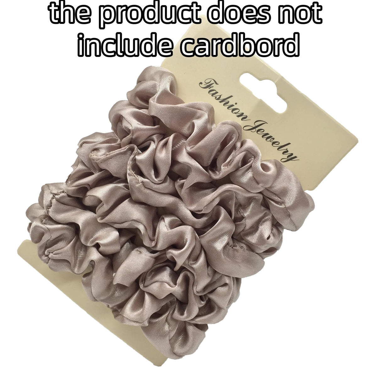 A pile of gray satin hair scrunchies displayed on a cardboard tag.