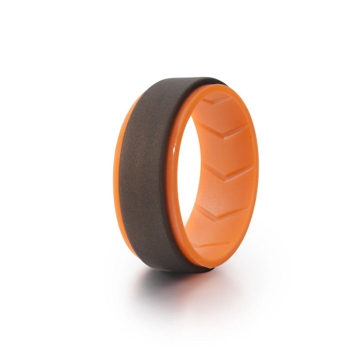 A close-up view of a black silicone wedding band and an orange silicone wedding band lying on a white surface.
