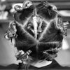 A close-up of a person's dark hair styled with professional fixed hair pins.