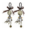A pair of antique gold-toned Saint Benedict protection charm sets with dark brown ribbons and dangling charms.