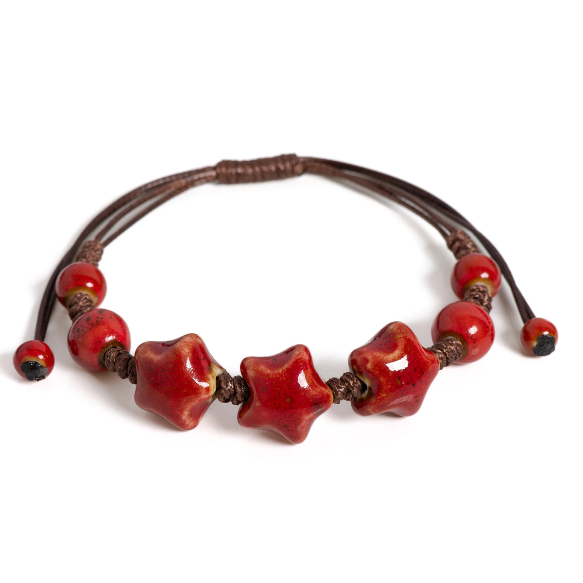 A handmade glazed ceramic star bracelet with reddish-brown beads and leather cord.