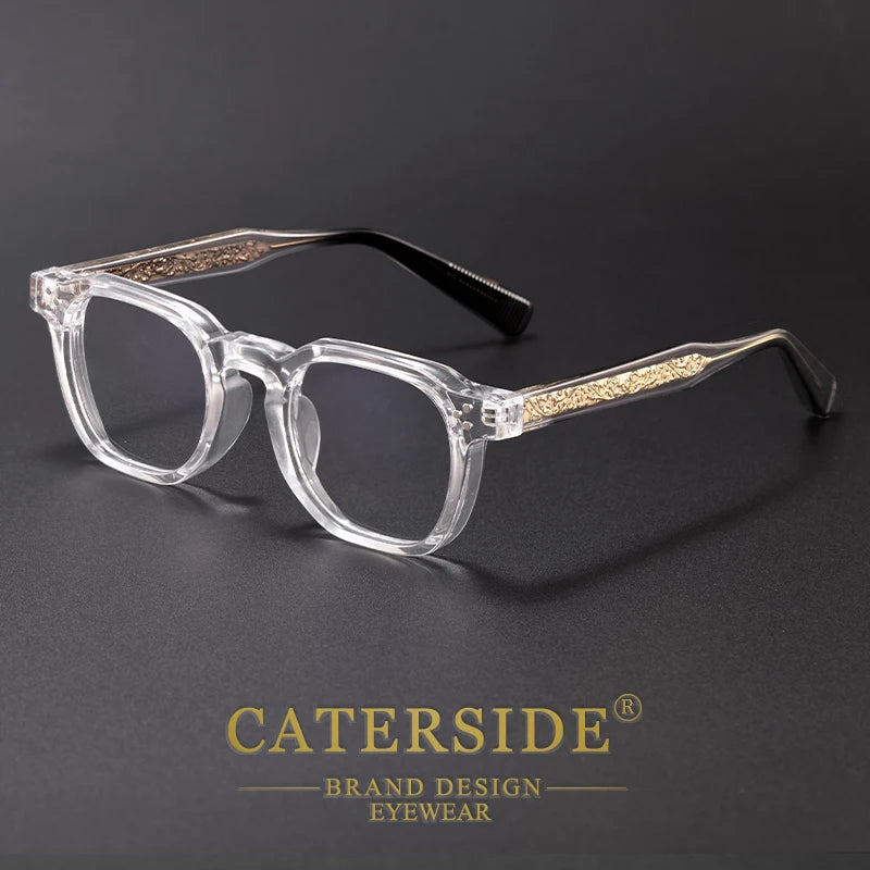 Clear acetate retro square eyeglasses with gold accents resting on a dark surface.