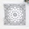 Black and white paisley bandana scarf featuring intricate floral and swirling patterns on a white background