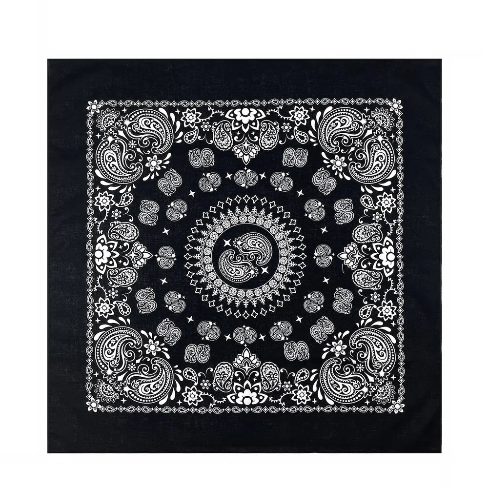 Black fabric featuring intricate white paisley and floral patterns on a square bandana scarf