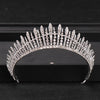 A close-up of a Baroque crystal rhinestone bridal tiara headpiece displayed on a dark surface.