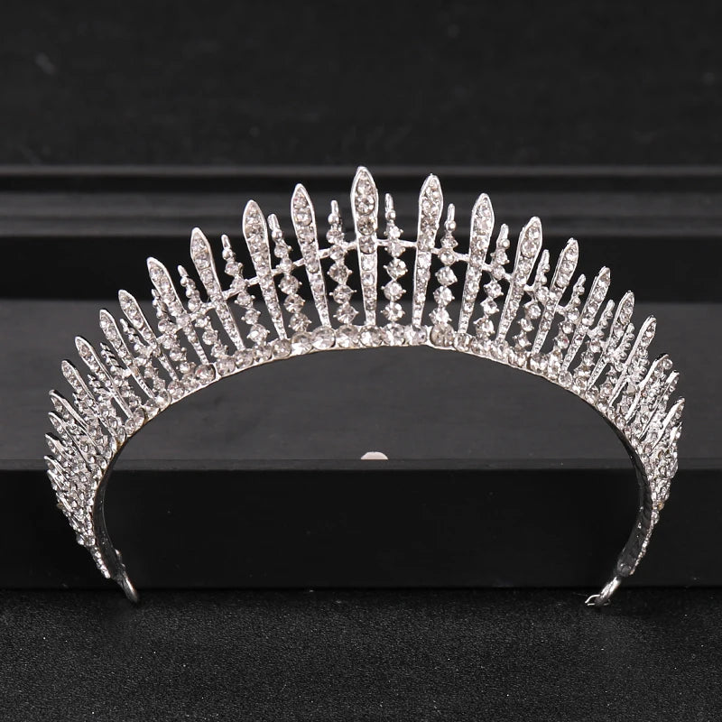 A close-up of a Baroque crystal rhinestone bridal tiara headpiece displayed on a dark surface.