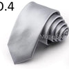 A silver satin neck tie folded into a rosette shape.