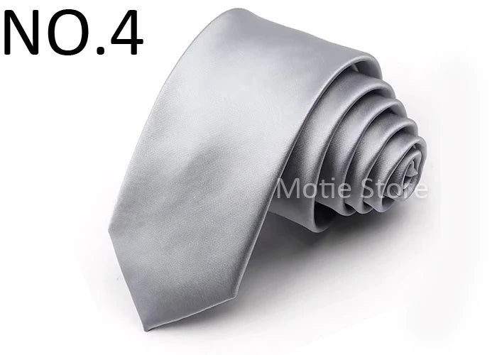A silver satin neck tie folded into a rosette shape.