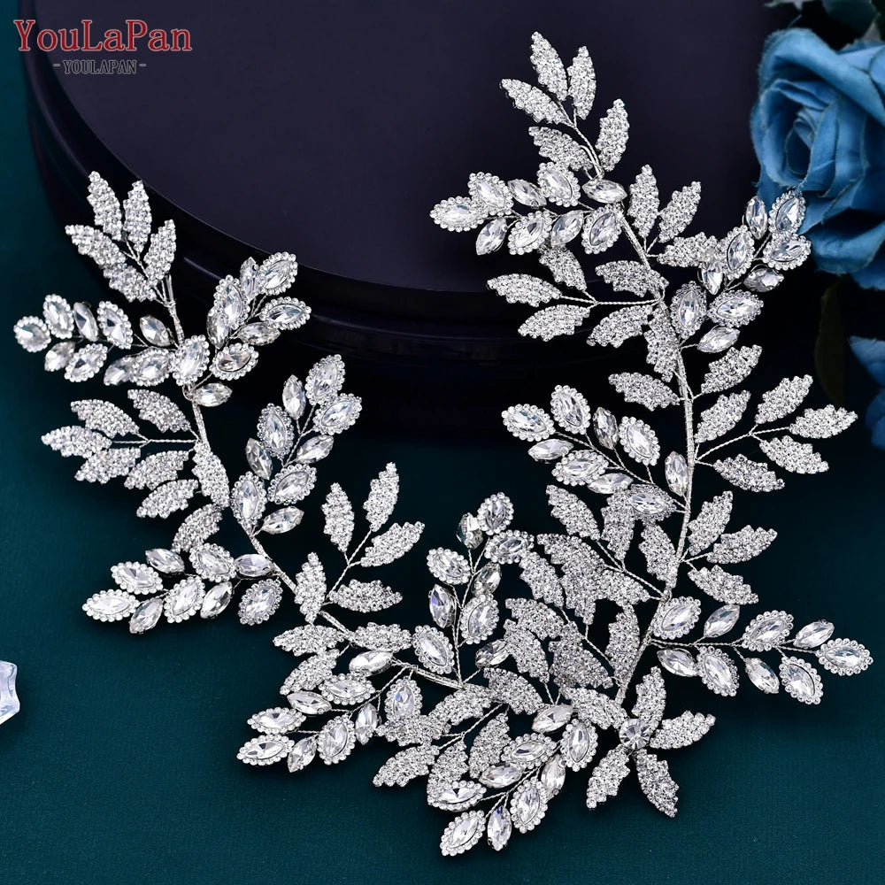 Silver rhinestone bridal headpiece featuring intricate floral and leaf designs