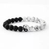 A bracelet made of smooth black and white stones representing the Yin Yang symbol.