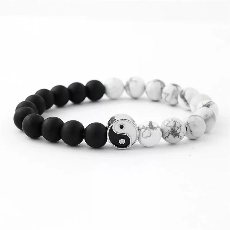 A bracelet made of smooth black and white stones representing the Yin Yang symbol.