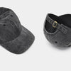 A dark gray washed cotton snapback cap with a black mesh back and a gold-toned strap detail.