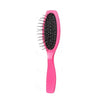 A pink anti-static steel comb hair brush for wig grooming with black bristles.