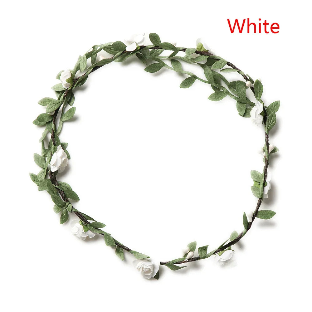 A wreath of green leaves and white flowers used as a bohemian flower headband for women.