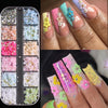 A collection of pink and white butterfly bow nail charms displayed on various fingernails.