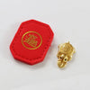 A red felt tag with gold lettering and a small gold turtle charm.
