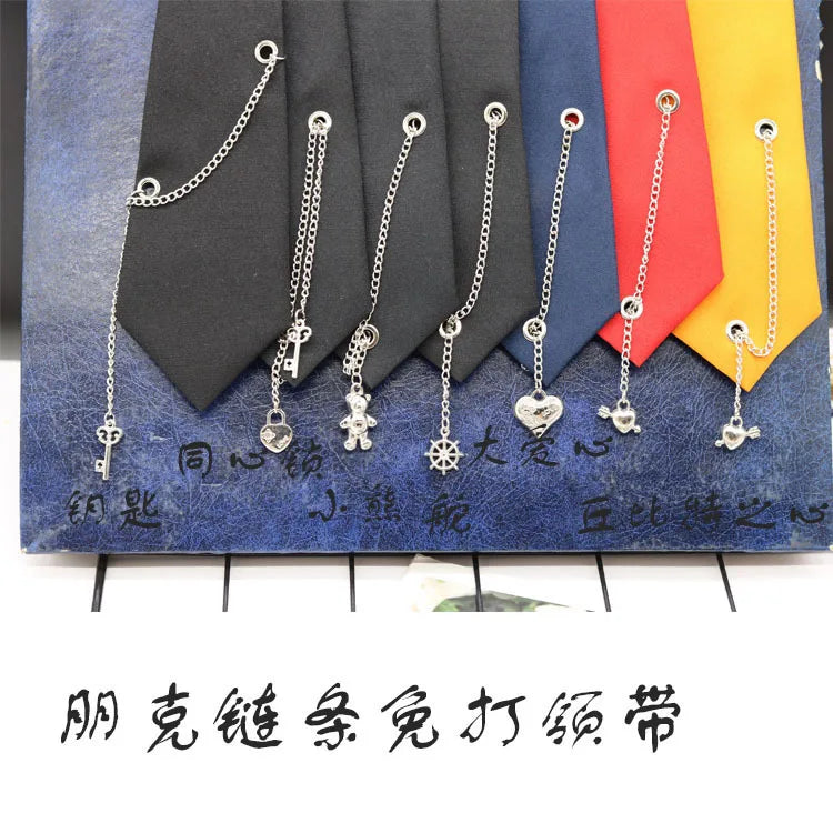 A set of silver chain necklaces displayed against a backdrop of various colored neckties.