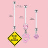 A set of elegant belly button rings featuring silver and pink gemstone charms on a pink background.
