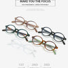 A collection of five round anti-blue light computer glasses in various shades of brown and clear frames.